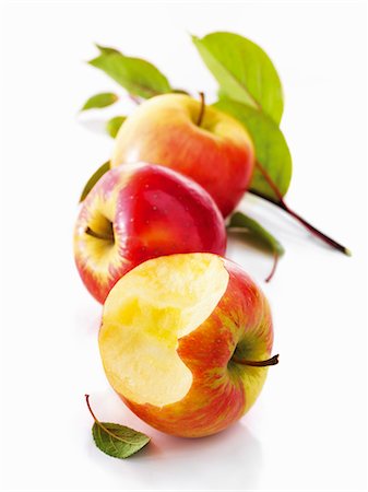 simsearch:659-06187916,k - Red apples, one with a bite taken out of it, with leaves Foto de stock - Sin royalties Premium, Código: 659-06154557