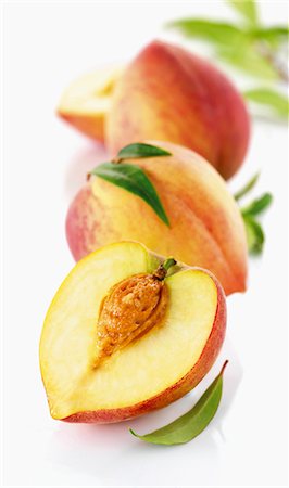 fresh peach - Three white peaches, whole and halved Stock Photo - Premium Royalty-Free, Code: 659-06154678