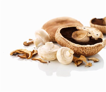 Various mushrooms on a white surface Stock Photo - Premium Royalty-Free, Code: 659-06154680