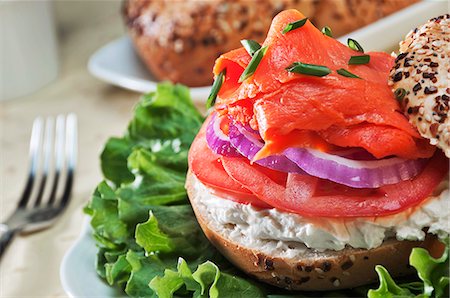 Smoked Salmon on a Bagel with Cream Cheese, Onions and Tomato Foto de stock - Sin royalties Premium, Código: 659-06154909