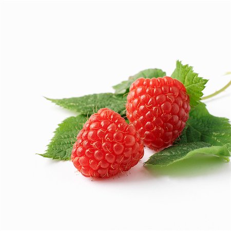 rasberries on white background - Two raspberries with leaves Stock Photo - Premium Royalty-Free, Code: 659-06154937