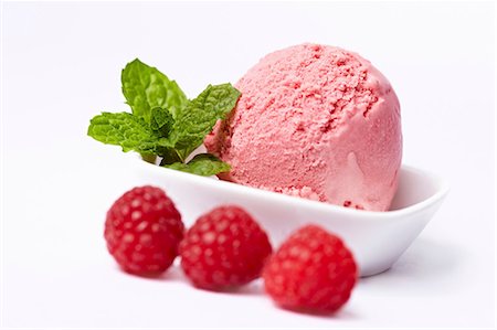 A scoop of raspberry ice cream and fresh raspberries Stock Photo - Premium Royalty-Free, Code: 659-06155137