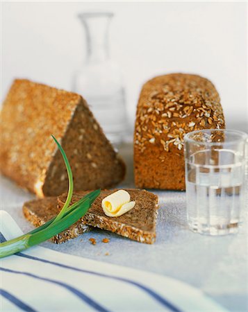 Wholemeal bead and a slice with a curl of butter Stock Photo - Premium Royalty-Free, Code: 659-06155240