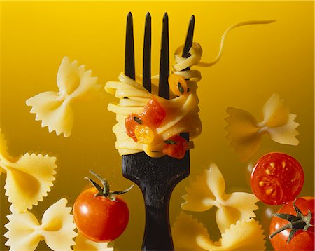 pasta and fork - Thin tagliatelle with tomatoes on a fork with farfalle Stock Photo - Premium Royalty-Free, Code: 659-06155260