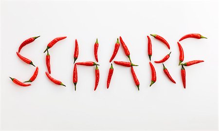 The word 'SCHARF' ('Spicy' in German) written in red chillies Foto de stock - Sin royalties Premium, Código: 659-06155312