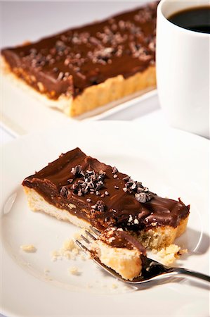simsearch:659-06900884,k - Piece of Chocolate Hazelnut Tart with Shortbread Crust; Fork; Espresso Stock Photo - Premium Royalty-Free, Code: 659-06155611