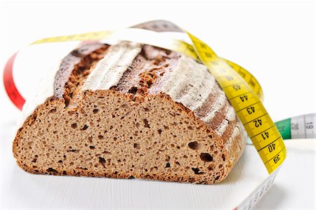 defocused light - Brown bread and a tape measure Stock Photo - Premium Royalty-Free, Code: 659-06155683