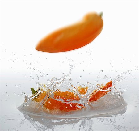 Pointed peppers falling into water Stock Photo - Premium Royalty-Free, Code: 659-06155969