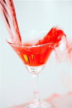 Red Martini being poured into a glass Stock Photo - Premium Royalty-Free, Code: 659-06155992