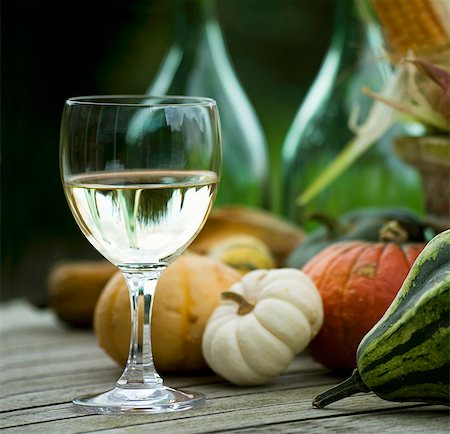 A glass of white wine and pumpkins on a wooden table Stock Photo - Premium Royalty-Free, Code: 659-06156054