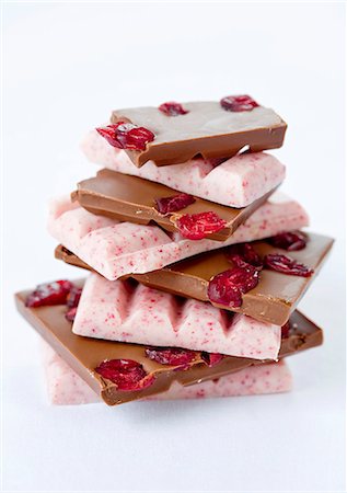 simsearch:659-06494052,k - A stack of various pieces of chocolate with cranberries Stock Photo - Premium Royalty-Free, Code: 659-06151139