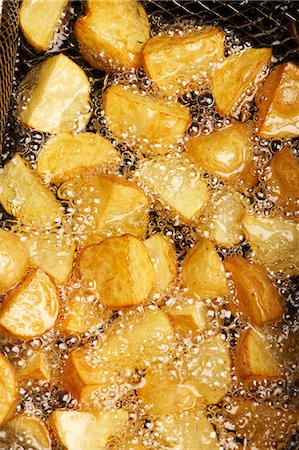 fried - Potatoes being fried in hot oil Stock Photo - Premium Royalty-Free, Code: 659-06151176