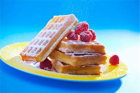 sugary - Waffles with raspberries and icing sugar Stock Photo - Premium Royalty-Free, Code: 659-06151328