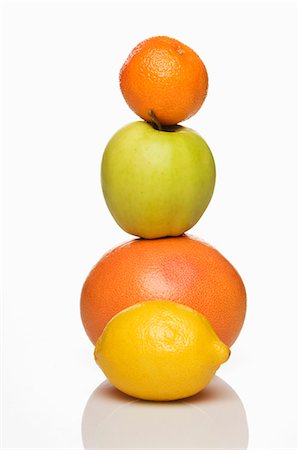 simsearch:659-06187916,k - A stack of citrus fruits and an apple Stock Photo - Premium Royalty-Free, Code: 659-06151395