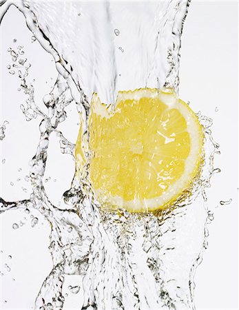 fruit splashing in water - Half a lemon under flowing water Stock Photo - Premium Royalty-Free, Code: 659-06151470