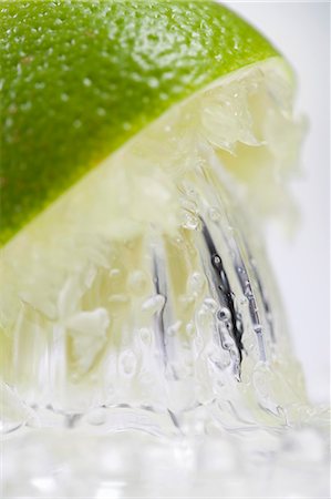 squeeze fruit - A lime being juiced (close-up) Stock Photo - Premium Royalty-Free, Code: 659-06151610