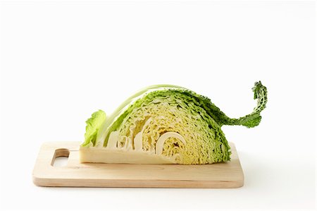 savoy cabbage - A quarter of a savoy cabage on a chopping board Stock Photo - Premium Royalty-Free, Code: 659-06151694