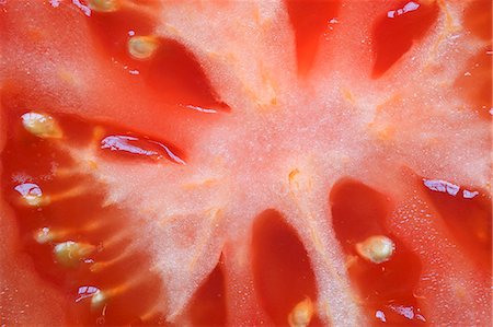 A sliced tomato (detail) Stock Photo - Premium Royalty-Free, Code: 659-06151707
