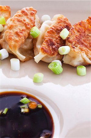 simsearch:659-06373793,k - Shrimp Potstickers with Green Onion and Ponzu Dipping Sauce Stock Photo - Premium Royalty-Free, Code: 659-06151819