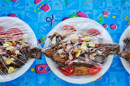 Sweet-sour tilapia on plates covered with clingfilm Stock Photo - Premium Royalty-Free, Code: 659-06151837