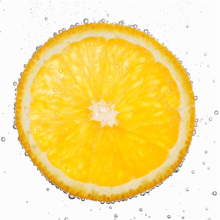 A slice of orange in water with air bubbles Stock Photo - Premium Royalty-Free, Code: 659-06152043