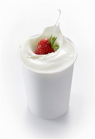 simsearch:659-07028243,k - A strawberry falling into a cup of yogurt Stock Photo - Premium Royalty-Free, Code: 659-06152054