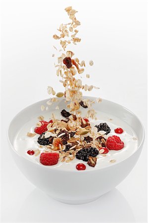 soft fruit yogurt - Cereals falling into yogurt muesli with berries Stock Photo - Premium Royalty-Free, Code: 659-06152075