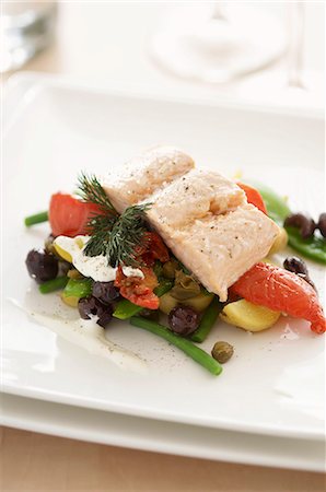 simsearch:659-07959202,k - Salmon fillet on a bed of summer vegetables (tomatoes, olives, green beans) Stock Photo - Premium Royalty-Free, Code: 659-06152140