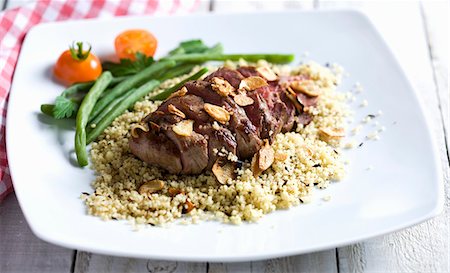 Beef with garlic on a bed of couscous Stock Photo - Premium Royalty-Free, Code: 659-06152185