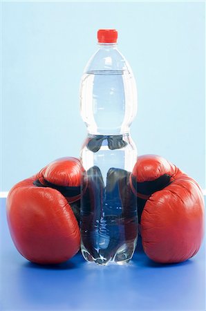 fitness water bottle - A bottle of mineral water and a pair of boxing gloves Stock Photo - Premium Royalty-Free, Code: 659-06152223