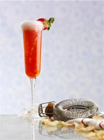 Strawberry champagne, a bar sieve and champagne corks Stock Photo - Premium Royalty-Free, Code: 659-06152526