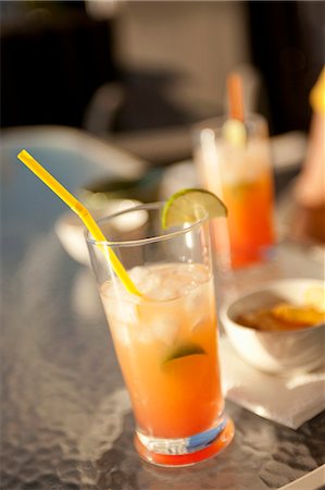 summer drink - Mai Tai with a Straw on a Glass Table Stock Photo - Premium Royalty-Free, Code: 659-06152721