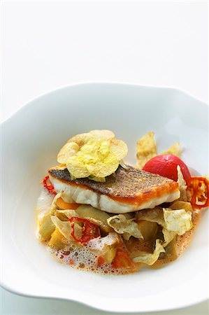 Bass with artichokes, tomatoes and braised onions Stock Photo - Premium Royalty-Free, Code: 659-06152812