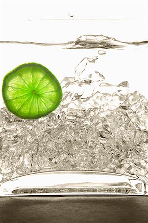 Ice Splashing into Water with Lime Slice Stock Photo - Premium Royalty-Free, Code: 659-06152867