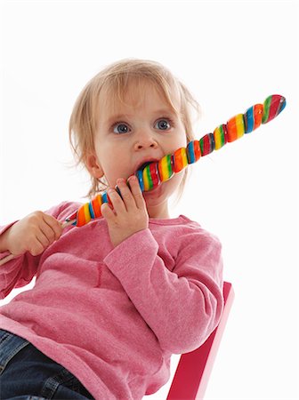 sucker - A small child eating a giant lolly Stock Photo - Premium Royalty-Free, Code: 659-06152936