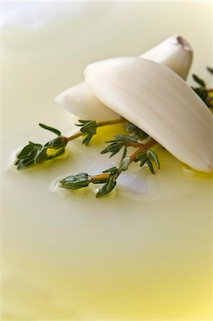 Two Garlic Cloves with Two Thyme Sprigs in Olive Oil Stock Photo - Premium Royalty-Free, Code: 659-06152939