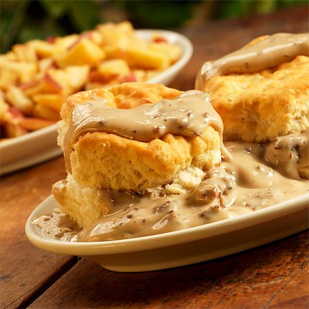 fatty - Biscuits with Sausage Gravy; On Rustic Table; Home Fries Stock Photo - Premium Royalty-Free, Code: 659-06152947