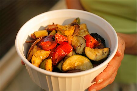 serving dish - Woman Carrying a Serving Bowl of Grilled Vegetables Stock Photo - Premium Royalty-Free, Code: 659-06152951