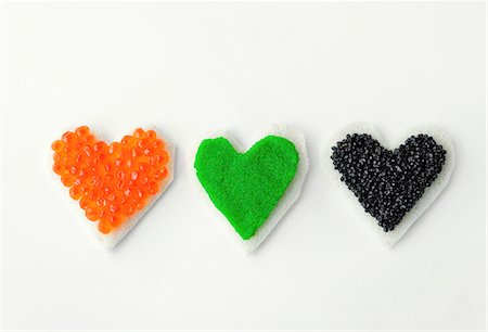 Three heart-shaped canapes with colourful caviar Stock Photo - Premium Royalty-Free, Code: 659-06153059