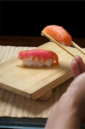 simsearch:659-08418941,k - Hand holding sushi in chopsticks Foto de stock - Sin royalties Premium, Código: 659-06153097