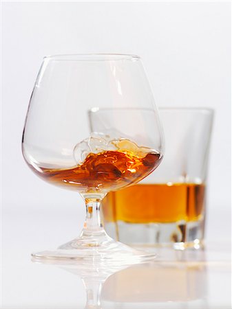 Cognac in a balloon glass and a glass of whiskey Stock Photo - Premium Royalty-Free, Code: 659-06153133