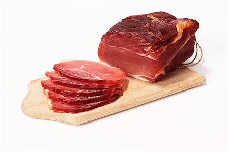 Cured pork loin on a cutting board Foto de stock - Sin royalties Premium, Código: 659-06153315