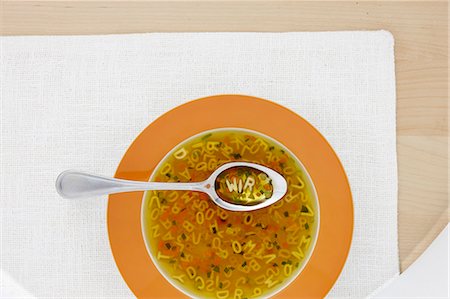 pasta, top view - Clear broth with vegetables and alphabet noodles Stock Photo - Premium Royalty-Free, Code: 659-06153332