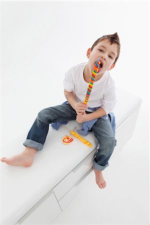 sucker - A little boy eating a giant lolly Stock Photo - Premium Royalty-Free, Code: 659-06153333