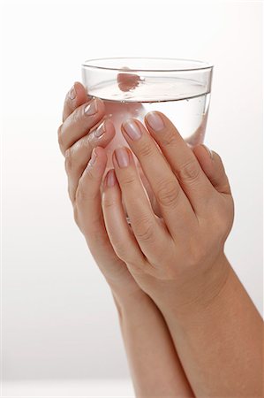 Hands holding a glass of water Stock Photo - Premium Royalty-Free, Code: 659-06153361