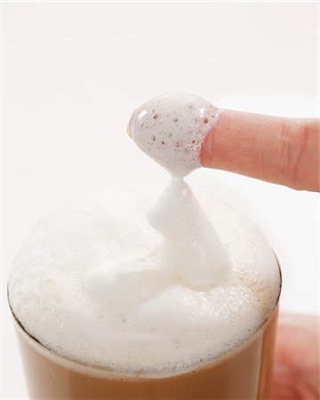 froth - Milk foam covered finger from a glass of Latte Macchiato Stock Photo - Premium Royalty-Free, Code: 659-06153379