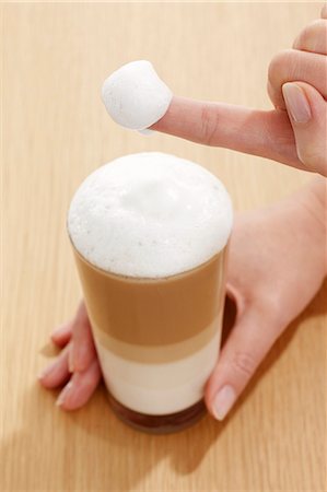 simsearch:659-08896141,k - Milk foam covered finger from a glass of Latte Macchiato Stock Photo - Premium Royalty-Free, Code: 659-06153380