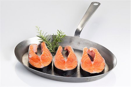 salmon steak - Fresh salmon steaks in a frying pan Stock Photo - Premium Royalty-Free, Code: 659-06153427