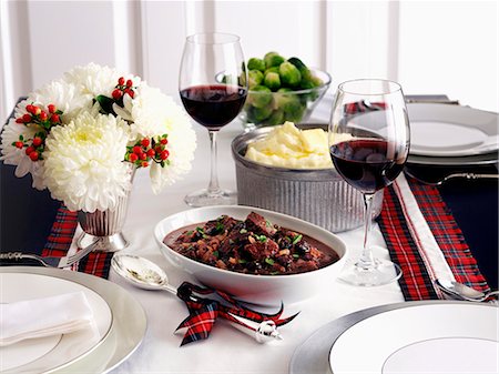 Saddle of venison, mashed potatoes and Brussels sprouts on a table decorated for Christmas Stock Photo - Premium Royalty-Free, Code: 659-06153545