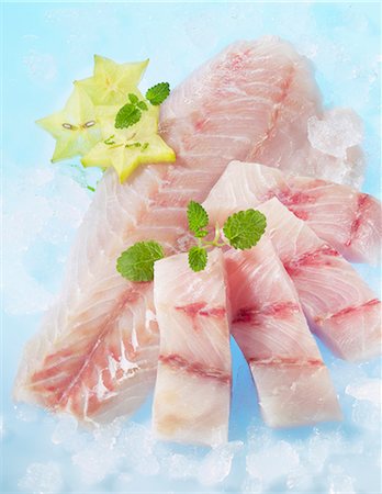 simsearch:659-06153435,k - Fresh Victoria perch fillets with lemon balm and star fruit Stock Photo - Premium Royalty-Free, Code: 659-06153697